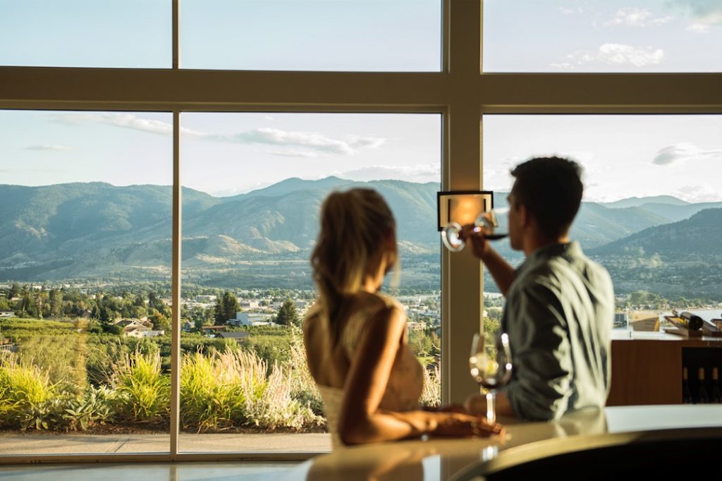 A couple sampling wine at Poplar Grove Winery. Photo Credit Destination BC/Kari Medig